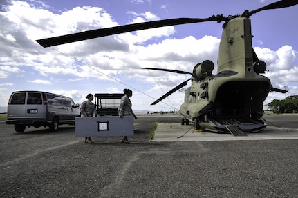 U.S. Air Force Capt. Amber El-Amin, Joint Task Force-Bravo Operations Medical Planner, and Senior Airman Synethia Robinson, JTF-Bravo medical operations noncommissioned-officer-in-charge, help load equipment into a 1st Battalion, 228th Aviation Regiment CH-47 Chinook helicopter July 25, 2016 at Soto Cano Air Base, Honduras. The aircraft is being loaded in preparation for a Medical Readiness Exercise mission in the Colón department of Honduras. The two Airmen play a vital role in the Joint Operations Planning Process - a process that includes building concepts of operation; synchronizing and de-conflicting all logistical and support elements; scheduling and leading meetings and rehearsal of concept drills; ensuring all mission personnel, to include Honduran employees, have all appropriate passport and country clearances; and that all personnel and equipment are manifested and ready for transport to MEDRETE locations throughout Central America. 