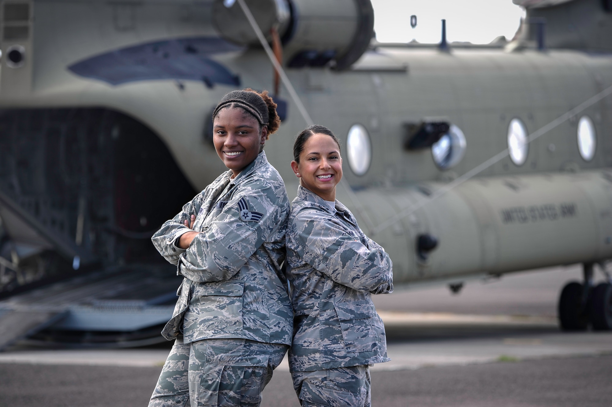 U.S. Air Force Capt. Amber El-Amin, Joint Task Force-Bravo Operations Medical Planner, and Senior Airman Synethia Robinson, JTF-Bravo medical operations noncommissioned-officer-in-charge, pose behind a 1st Battalion, 228th Aviation Regiment CH-47 Chinook helicopter July 25, 2016 at Soto Cano Air Base, Honduras. The aircraft is being loaded in preparation for a Medical Readiness Exercise mission in the Colón department of Honduras. The duo spends approximately 180-200 hours over 12 weeks preparing for each MEDRETE - events that have been the backbone of JTF-Bravo’s humanitarian mission in Central America for the past 23 years and have touched the lives of hundreds of thousands of people, built partner nation capacity and fostered goodwill towards the U.S. in the region. (U.S. Air Force photo by Staff Sgt. Siuta B. Ika)