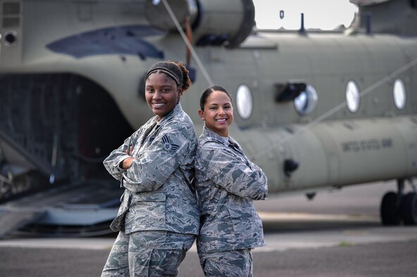 Capt. Amber El-Amin, a Joint Task Force-Bravo operations medical planner, and Senior Airman Synethia Robinson, the JTF-Bravo medical operations NCO in charge, stand in front of a CH-47 Chinook July 25, 2016, at Soto Cano Air Base, Honduras. El-Amin and Robinson play a vital role in the joint operations planning process for JTF-Bravo missions. (U.S. Air Force photo/Staff Sgt. Siuta B. Ika) 