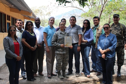 U.S. Air Force Capt. Amber El-Amin (left), Joint Task Force-Bravo Operations Medical Planner, is presented an appreciation award for the support given to the people of Copán by JTF-Bravo service members, in Ostumán, Copán, Honduras, April 28, 2016. The Regional Director visited the Medical Readiness Training Exercise location as part of a Civic Leader Engagement between regional key leaders, U.S. Embassy personnel and JTF-Bravo representatives. (U.S. Army photo by Maria Pinel)