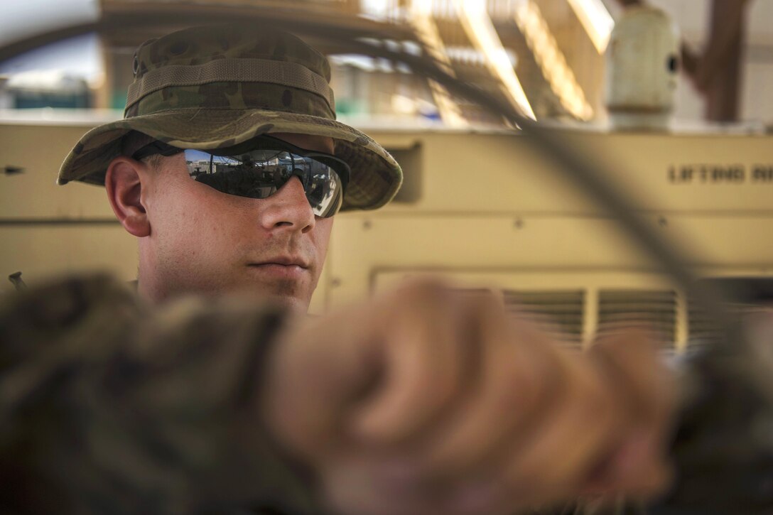 Air Force Staff Sgt. James Hughes turns the knob on an oxygen tank during an inspection at Bagram Airfield, Afghanistan, July 18, 2016. Hughes is a biomedical equipment technician assigned to the 455th Expeditionary Medical Group. Air Force photo by Senior Airman Justyn M. Freeman