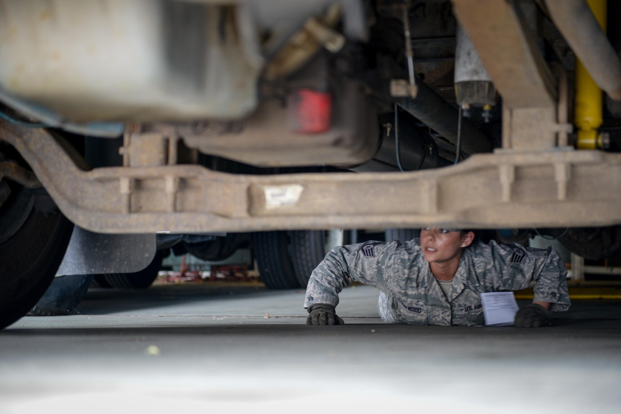 Staff Sgt. Lisa M. Haywood, 934th Logistics Readiness Squadron, performs routine inspections under a vehicle during a Quality Assurance inspection in a vehicle operations garage at the Minneapolis-St. Paul Air Reserve Station. The 934 LRS QA section won the Air Force Reserve Command’s 2015 Quality Assurance award. (U.S. Air Force photo by Staff Sgt. Corban D. Lundborg.)

