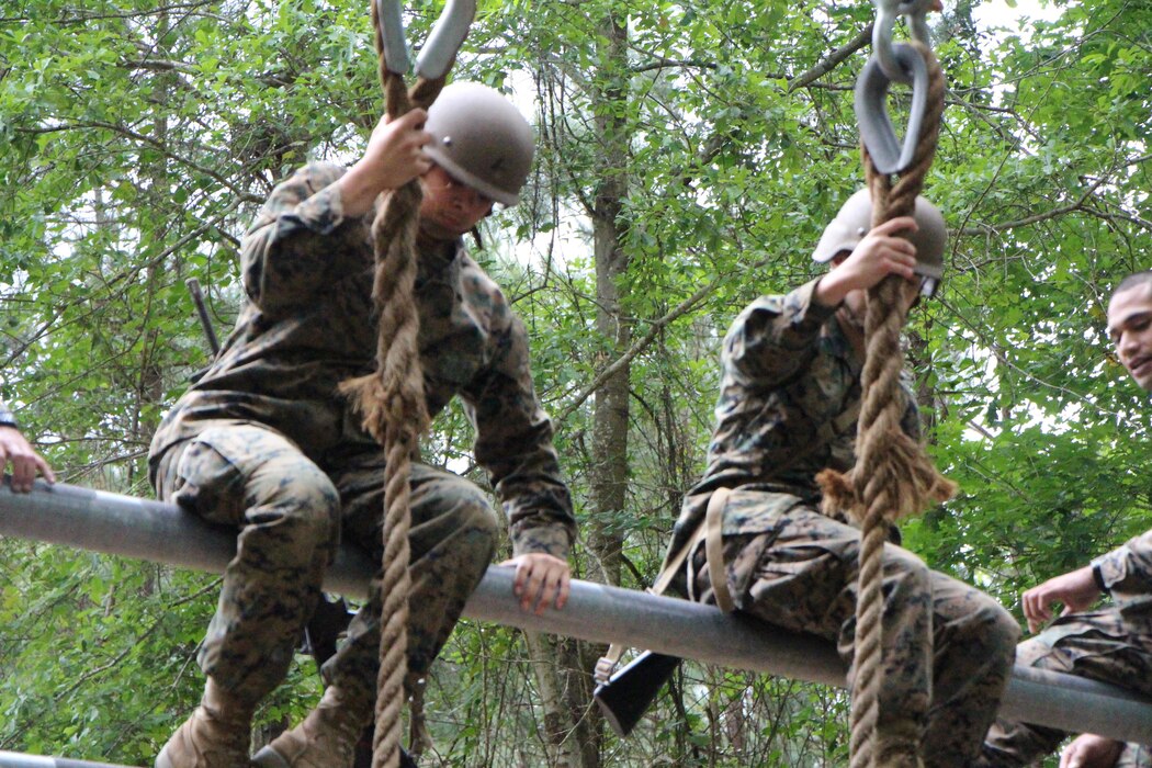 FMTB-E student participates on the obstacle course.  The obstacle is designed to test students strength and ability to safely move past obstacles.