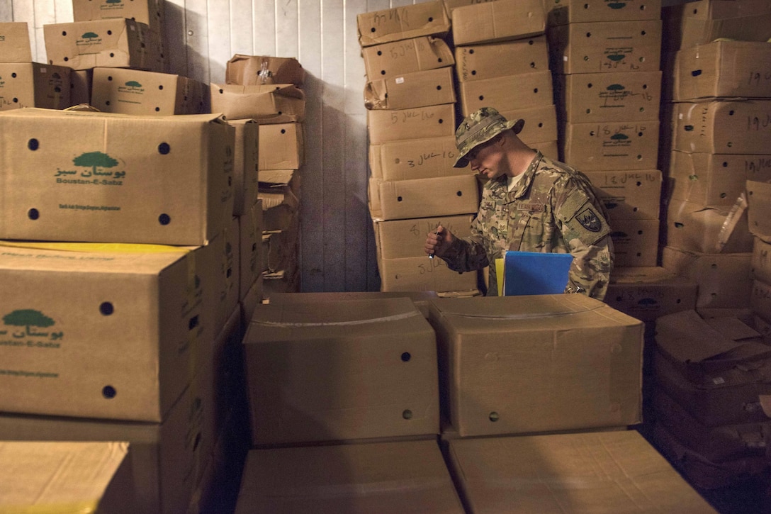 Air Force Tech Sgt. Rusty Thomas inspects the inside of a freezer at Bagram Airfield, Afghanistan, July 21, 2016. Thomas, a public health technician assigned to the 455th Expeditionary Medical Group, inspects facilities to ensure that they are sanitary and comply with food code standards. Air Force photo by Senior Airman Justyn M. Freeman