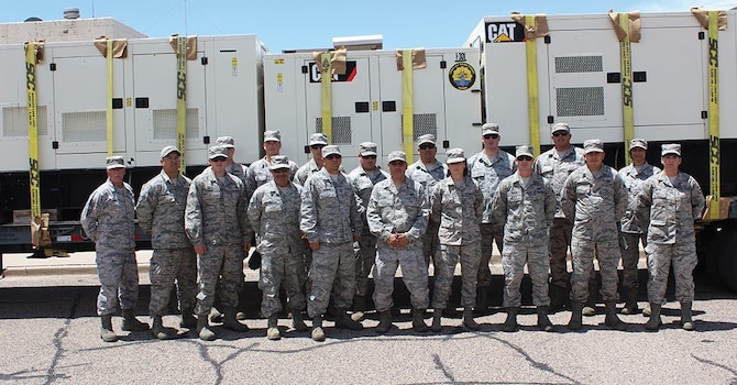 Members of the Air National Guard 150th Special Operations Wing Prime Power unit from Kirtland Air Force Base pose with some of their generators after returning Monday from a training exercise in Wisconsin. They convoyed for more than 1,400 miles to participate in the national exercise, practicing for helping with disaster relief at the far reaches of their response area. (Photo by Bud Cordova)

