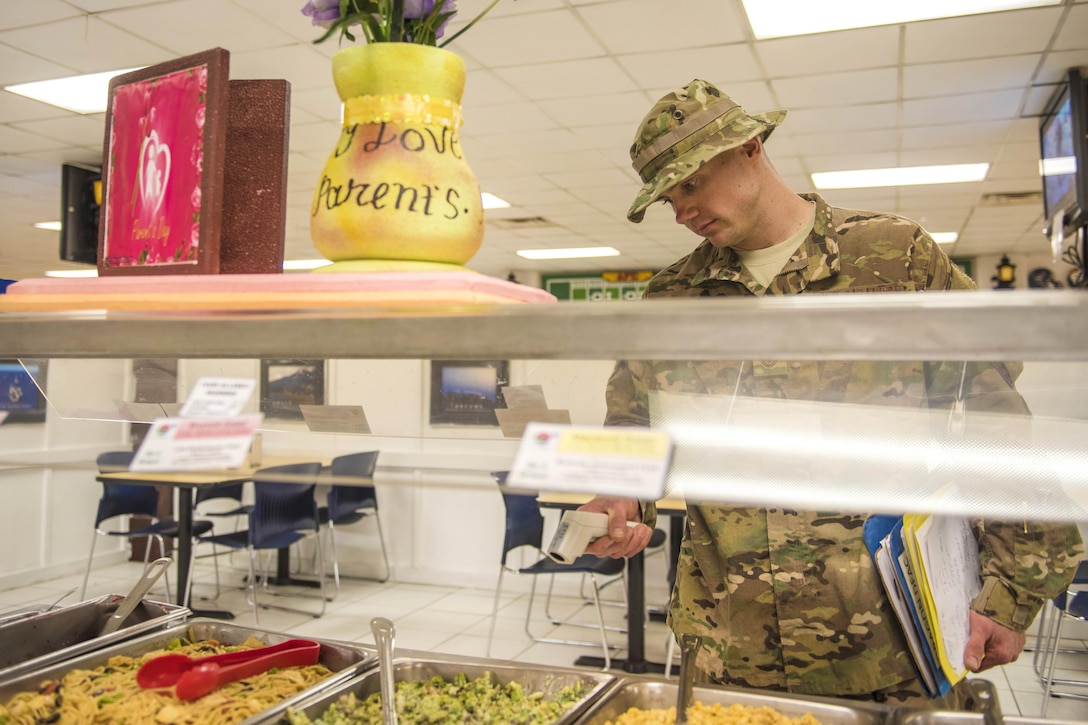 Air Force Tech Sgt. Rusty Thomas checks food temperature with an infrared thermometer at Bagram Airfield, Afghanistan, July 21, 2016. Thomas is a public health technician assigned to the 455th Expeditionary Medical Group. Air Force photo by Senior Airman Justyn M. Freeman