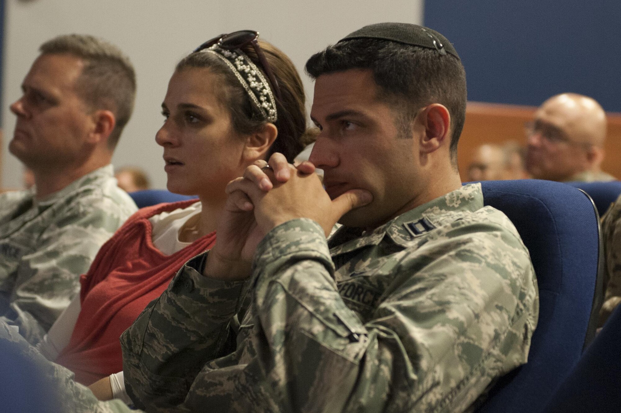 Capt. Jonathan Goldstein, 305th Air Mobility Wing executive officer and C-17 pilot, and his wife, Michelle Goldstein, listen to Jonathan’s grandfather, Sol Goldstein, tell his story at the McGuire Theater at Joint Base McGuire-Dix-Lakehurst, N.J., July 26, 2016. Sol is a World War II veteran and his story recalled his fights and close calls from Normandy to Bastogne.