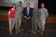 Sol Goldstein poses for a photograph with Michelle Goldstein, Capt. Jonathan Goldstein, Col. Darren Cole, and Chief Master Sgt. Timothy Pachasa, at the McGuire Theater at Joint Base McGuire-Dix-Lakehurst, N.J., July 26, 2016. Sol visited the Joint Base as part of a monthly professional development seminar hosted by the 305th Air Mobility Wing. Jonathan is a 305th AMW executive officer and C-17 instructor pilot, Cole is the 305th AMW commander and Pachasa is the 305th AMW command chief.