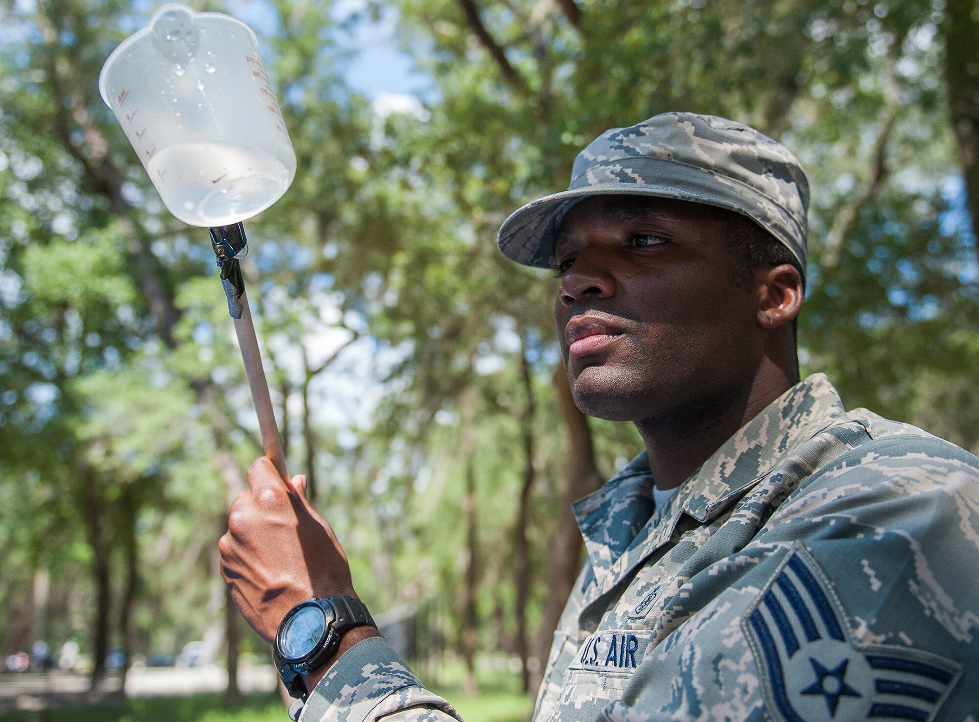 Staff Sgt Derrick Jones, 96th Aerospace Medicine Squadron public health technician, checks for mosquito larvae using a larvae dipper July 20 at Eglin Air Force Base, Fla. Jones checks the retention ponds and standing water after rainy weather periods for mosquito larvae. If larvae are found, they are collected, preserved and shipped to a lab for testing. (U.S. Air Force photo/Ilka Cole) 