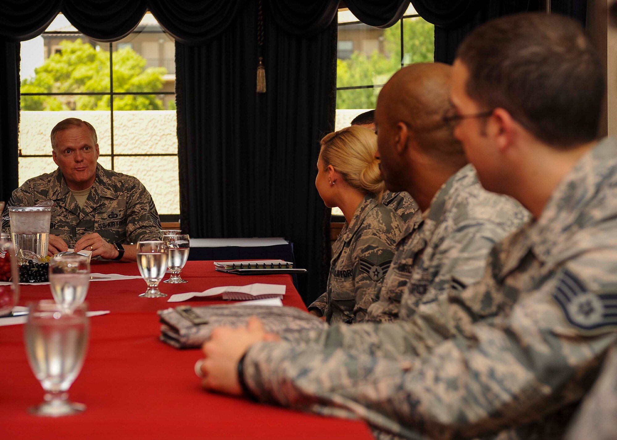 Chief Master Sgt. of the Air Force James A. Cody has a discussion with Airmen during a meet and greet in the Thunderbird room located at the club on Nellis Air Force Base, Nev., July 27, 2016. While meeting with Airmen, Cody discussed Air Force topics that may relate to an Airmen’s career field and asked Airmen their opinions on how to make the Air Force better as a whole. (U.S. Air Force photo by Senior Airman Jake Carter/Released)