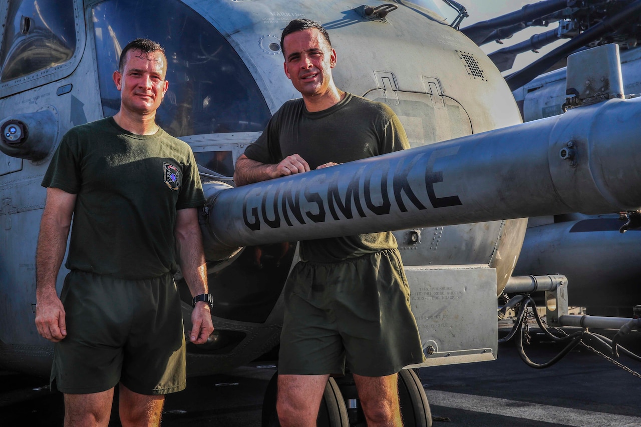 Marine Corps Lt. Col. Jonathan R. Smith, left, the ground combat element commander with the 13th Marine Expeditionary Unit, and Maj. Michael F. Smith, air combat element operations officer with the 13th MEU, stand next to the CH-53E Super Stallion detachment flagship “Gunsmoke” aboard the amphibious assault ship USS Boxer, May 13, 2016. The flagship is piloted by Michael and is named after the 13th MEU's Battalion Landing Team, which is commanded by Jonathan. Marine Corps photo by Cpl. Alvin Pujols