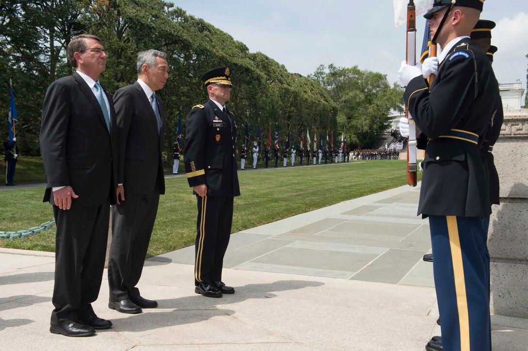 Defense Secretary Ash Carter and Prime Minister of Singapore Lee Hsien Loong pay respects their countries' flags at the Tomb of the Unknown Soldier at Arlington National Cemetery in Virginia, Aug. 1, 2016. DoD photo by Navy Petty Officer 1st Class Tim D. Godbee