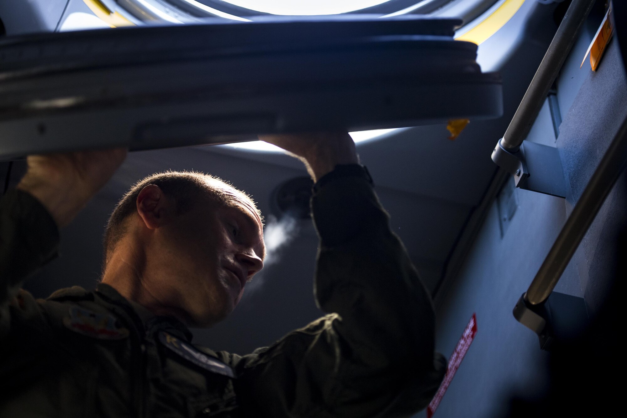 U.S. Air Force Master Sgt. Brian McAfee, 71st Rescue Squadron loadmaster, removes an access hatch during pre-flight checks in an HC-130J Combat King II, July 29, 2016, at Moody Air Force Base, Ga. This flight marked the first time an HC-130J landed at the unimproved landing zone on Bemiss Field, part of Grand Bay Bombing and Gunnery Range, which was previously used for airdrops and helicopter landings. The landing validated the pilot’s training for future operations in austere locations and met requirements for training that cannot be accomplished on paved runways or assault strips. (U.S. Air Force photo by Staff Sgt. Ryan Callaghan)
