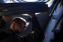 U.S. Air Force Master Sgt. Brian McAfee, 71st Rescue Squadron loadmaster, removes an access hatch during pre-flight checks in an HC-130J Combat King II, July 29, 2016, at Moody Air Force Base, Ga. This flight marked the first time an HC-130J landed at the unimproved landing zone on Bemiss Field, part of Grand Bay Bombing and Gunnery Range, which was previously used for airdrops and helicopter landings. The landing validated the pilot’s training for future operations in austere locations and met requirements for training that cannot be accomplished on paved runways or assault strips. (U.S. Air Force photo by Staff Sgt. Ryan Callaghan)
