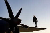 U.S. Air Force Master Sgt. Brian McAfee, 71st Rescue Squadron loadmaster, walks down the wing of an HC-130J Combat King II during pre-flight checks, July 29, 2016, at Moody Air Force Base, Ga. This flight marked the first time an HC-130J landed at the unimproved landing zone on Bemiss Field, part of Grand Bay Bombing and Gunnery Range, which was previously used for airdrops and helicopter landings. The landing validated the pilot’s training for future operations in austere locations and met requirements for training that cannot be accomplished on paved runways or assault strips. (U.S. Air Force photo by Staff Sgt. Ryan Callaghan)
