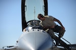 U.S. Air Force Tech. Sgt. Sean Romero, left and Senior Airman Mark Cavanaugh, crew chiefs with the New Jersey Air National Guard's 177th Fighter Wing, work inside the cockpit of an F-16 Fighting Falcon during Red Flag 16-3, July 20, 2016, on Nellis Air Force Base, Nev. 