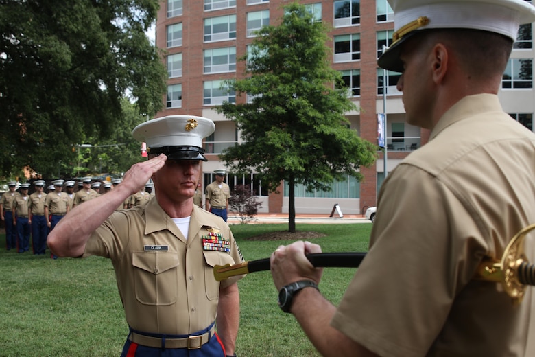 Sgt. Maj. Jonathan W. Clark salutes Maj. Richard P. Neikirk, commanding officer of Recruiting Station Raleigh, during a relief and appointment ceremony June 30 at the North Carolina State University Memorial Bell Tower, NC. Clark relieved Sgt. Maj. Jim E. Lanham who is to report   to Okinawa, Japan, as the 31st Marine Expeditionary Unit sergeant major. (U.S. Marine Corps photo by Sgt. Antonio J. Rubio/Released)