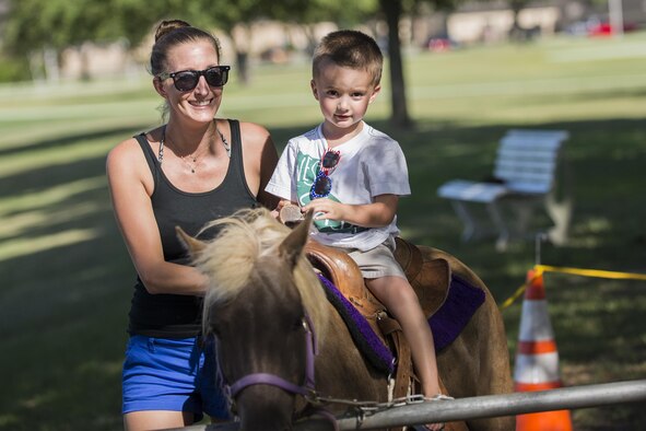 Leah and Ethan Gasparetto, family of U.S. Air Force Tech. Sgt. Jonathan Gasparetto, 23d Force Support Squadron, pose for a photo while riding a pony at the End of Summer Bash, July 29, 2016, at Moody Air Force Base, Ga. In addition to pony rides, children met different species of animals in a petting zoo. (U.S. Air Force photo by Airman Daniel Snider)
