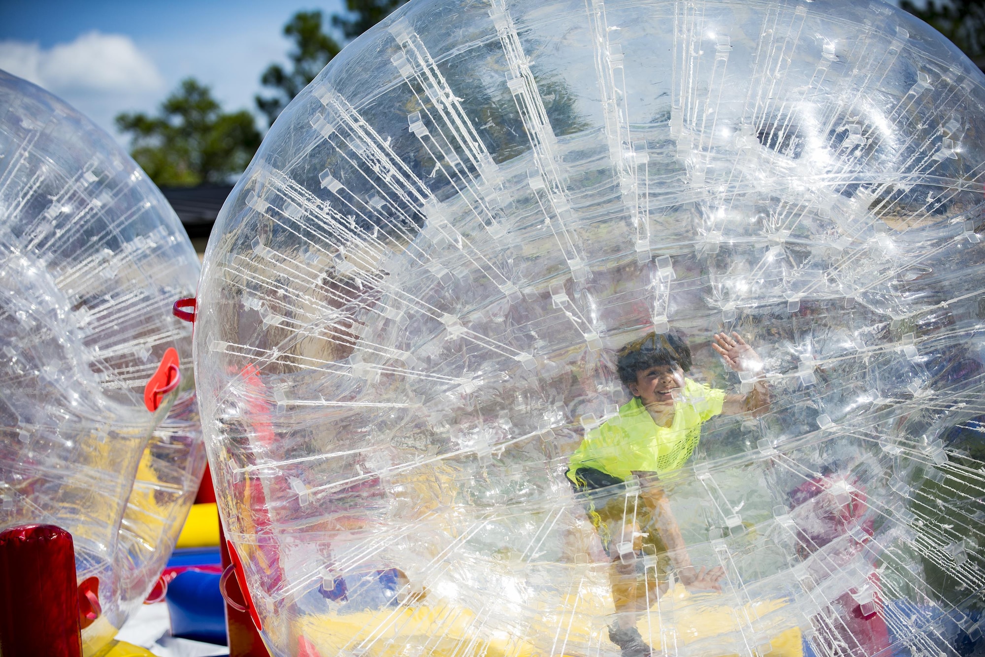 An obstacle course participant rolls in a human-hamster ball, during the End of Summer Bash, July 29, 2016, at Moody Air Force Base, Ga. Participants rolled across an array of obstacles inside the balls in order to win the race. (U.S. Air Force photo by Airman Daniel Snider)
