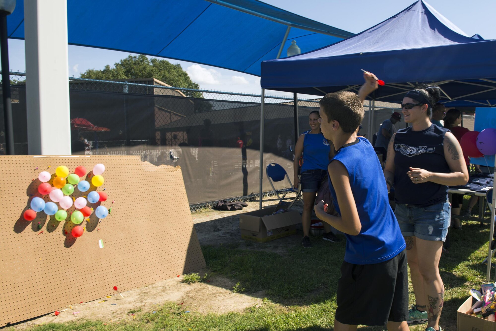 Matthew Bean, son of retired U.S. Air Force Tech. Sgt. James Bean, aims to burst a balloon during the End of Summer Bash, July 29, 2016, at Moody Air Force Base, Ga. The free, carnival-style event for Team Moody’s Airmen and families offered free food and included more than 15 activities to include an animal show, pony rides, magic show and several inflatable activities. (U.S. Air Force photo by Airman 1st Class Greg Nash)