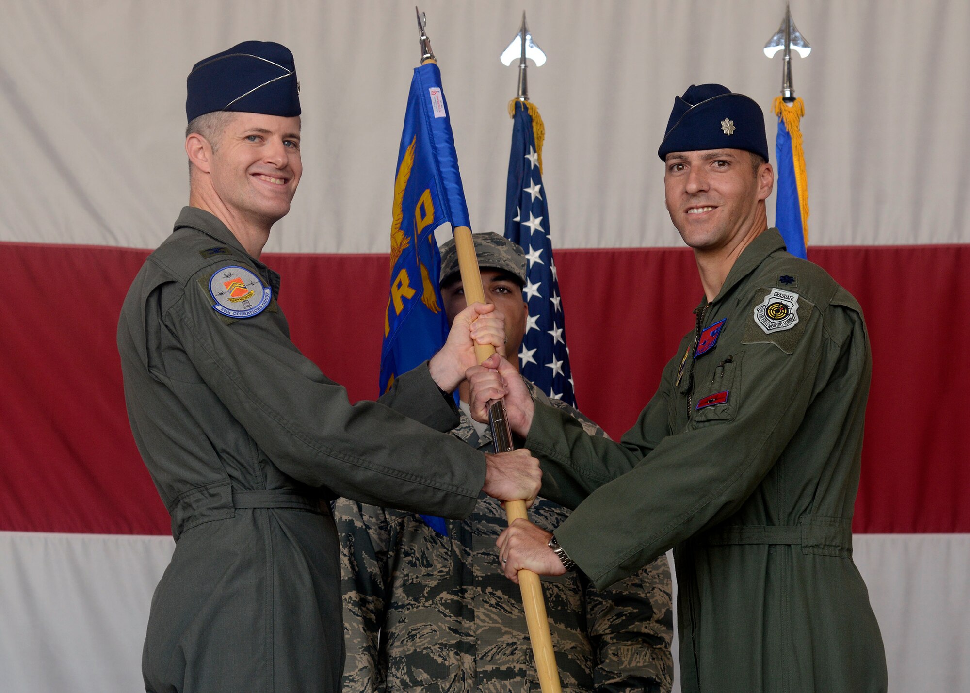 Col. Benjamin Bishop, 56th Operations Group commander, passes the guidon to Lt. Col. Matthew Vedder as he assumes command of the 63rd Fighter Squadron Aug. 1, 2016 at Luke Air Force Base, Ariz. The 63rd FS is scheduled to begin accepting F-35 Lightning II jets in March 2017 and will be joined by partner nation Turkey. (U.S. Air Force photo by Senior Airman Devante Williams)