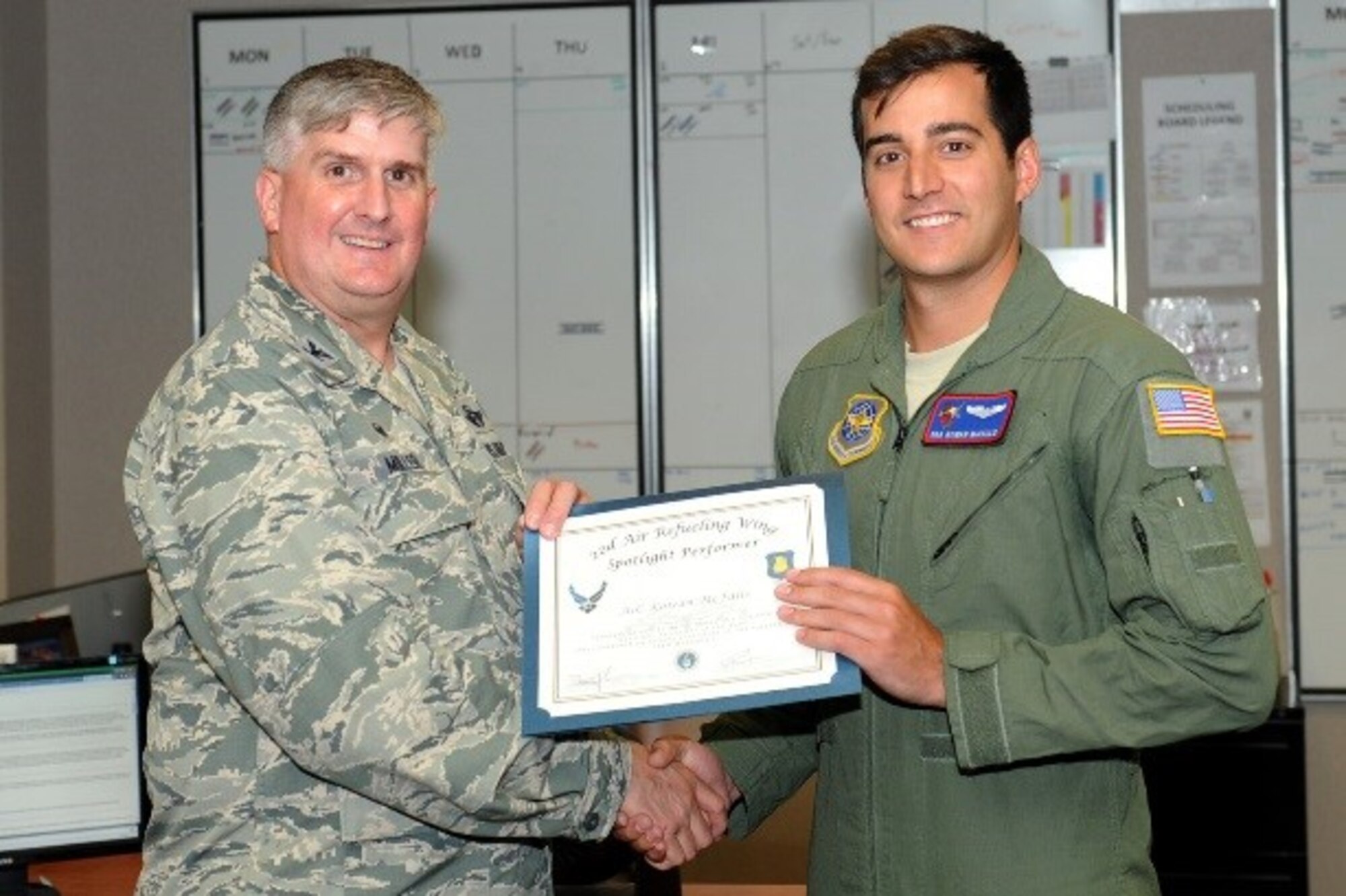 Senior Airman Kowan McFalls, 349th Air Refueling Squadron boom operator, poses with Col. Albert Miller, 22nd Air Refueling Wing commander, July 26, 2016, at McConnell Air Force Base, Kan. McFalls received the spotlight performer for the week of April 25-29. (U.S. Air Force photo/Senior Airman David Bernal Del Agua)