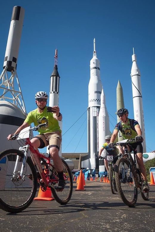 Steve Goolsby bikes around the Space and Rocket Center.