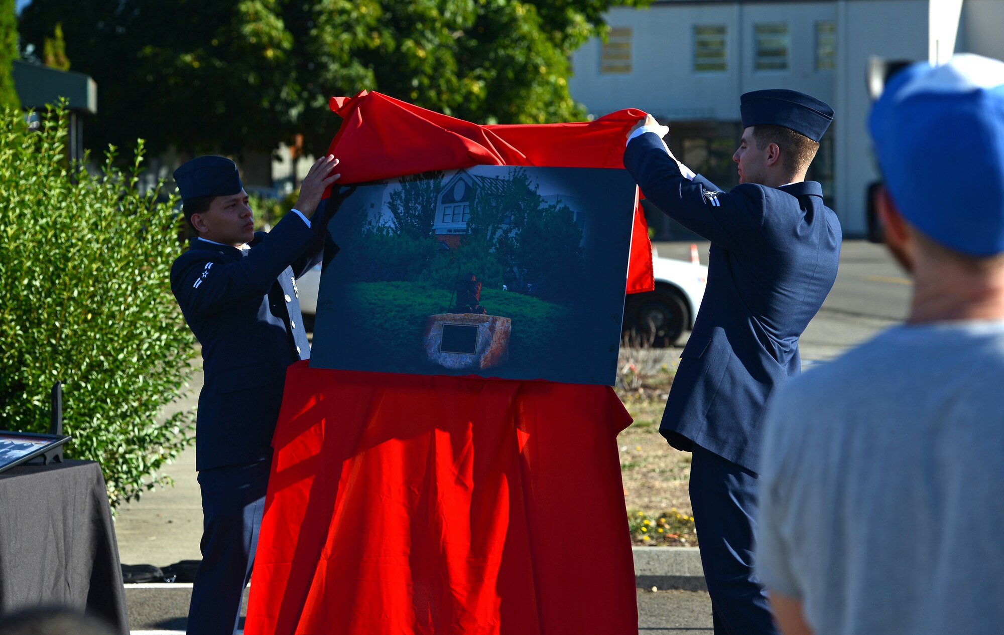 Air Force firefighters from the 627th Civil Engineer Squadron unveil a rendering of the Legacy Monument during a memorial ceremony, July 26, 2016, at Joint Base Lewis-McChord, Wash. The Legacy Monument will be constructed in front of Station 105 on McChord Field to memorialize the legacy of Air Force firefighters who served at McChord from 1946-2017. (U.S. Air Force photo/Senior Airman Jacob Jimenez) 