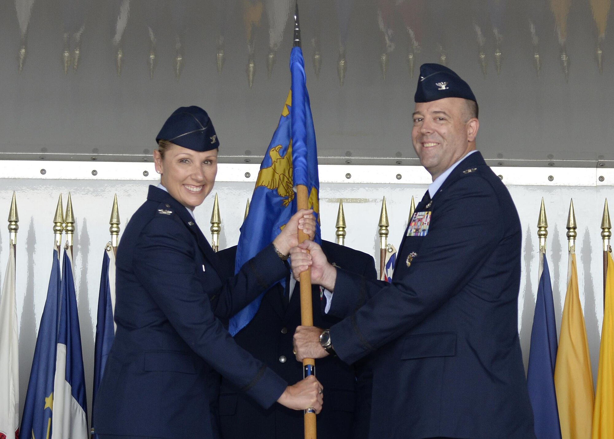 Col. April Vogel, commander of the 6th Air Mobility Wing, passes the 6th Mission Support Group (MSG) guidon to the incoming group commander, Col. Patrick Miller during a change of command ceremony at MacDill Air Force Base, Fla., August 1, 2016. The ceremony marks the beginning of Miller’s tenure as the 6th MSG commander. (U.S. Air Force photo by Tech. Sgt. Krystie Martinez)