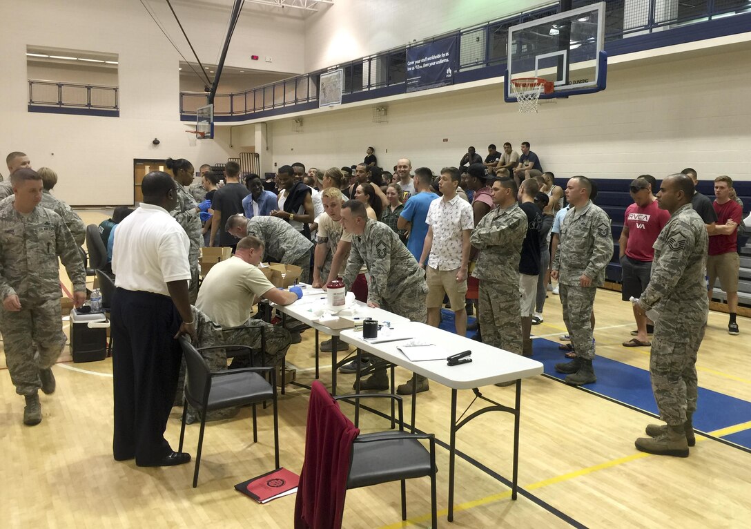 U.S. Air Force Airmen prepare for urinalysis testing at Shellbank Fitness Center during Operation Nighthawk at Langley Air Force Base, Va., July 24, 2016. During the operation, 633rd Security Forces Squadron conducted a 100 percent vehicle inspection and military urinalysis testing while using the fitness center to inspect more than 200 vehicles and 300 individuals entering Langley between the hours of 11 p.m. through 3 a.m.  (U.S. Air Force photo)