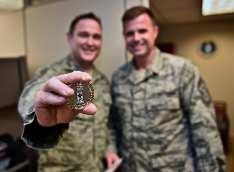 Tech. Sgt. Jacob Spencer shows the challenge coin recently given to him by the 932nd Command Chief, Chief Master Sgt. Chad Welch for his superior academic achievement while attending the chaplain assistant tech school. Spencer earned a 91 percent and the Air Education and Training Command Commander's Award.  Spencer said his favorite memory while at school was visiting with vets and hearing their stories. It helped him be prepared for his new career as a chaplain assistant, he said.  (U.S. Air Force photo/Tech. Sgt. Christopher Parr)