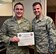 932nd Command Chief, Chief Master Sgt. Chad Welch presents Tech. Sgt. Jacob Spencer his Air Education and Training Command Commander's Award for superior academic achievement, July 9, 2016, Scott Air Force Base, Illinois.  Spencer earned the award for having a final grade of 91 percent during the six week chaplain assistant tech school.  Spencer had been a assigned to the 932nd firefighters, and is a civilian firefighter, but wanted to be able to help people in a different way.  "I like that I can help people with follow up care," said Spencer.  "I'm there to help, no matter their faith.'  (U.S. Air Force photo/Tech. Sgt. Christopher Parr)