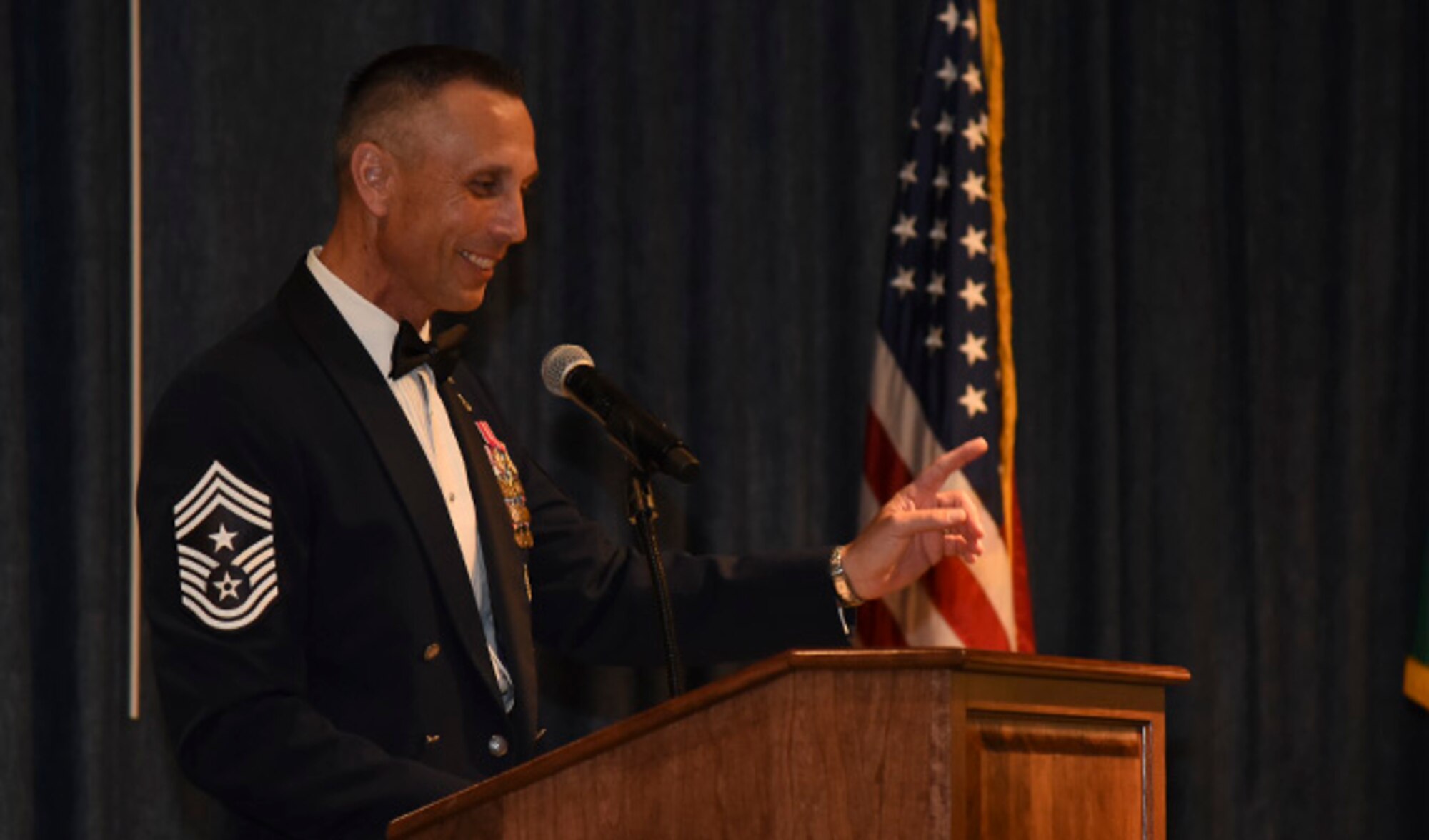Chief Master Sgt. Todd Petzel, 18th Air Force command chief, delivers a speech during the Senior NCO Recognition Ceremony at the Red Morgan Center July 29. Petzel was joined by Col. Ryan Samuelson, 92nd Air Refueling Wing commander, and Chief Master Sgt. Bill Fitch, 92nd ARW acting command chief, in congratulating Fairchild’s newest selectees. (U.S. Air Force photo/Airman 1st Class Mackenzie Richardson)