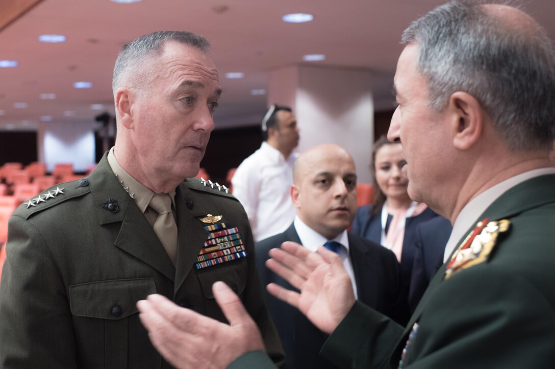 Marine Corps Gen. Joe Dunford, chairman of the Joint Chiefs of Staff, talks with his Turkish counterpart, Gen. Hulusi Akar, while touring the Turkish Grand National Assembly in Ankara, Turkey, Aug. 1, 2016. DoD photo by Navy Petty Officer 2nd Class Dominique A. Pineiro
