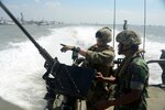 In this file photo, Gunner's Mate 2nd Class Joseph Quartararo, assigned to Coastal Riverine Squadron (CRS) 3, speaks to an Indonesian “Kopaska” Naval Special Forces member while participating in a familiarization ride aboard a riverine command boat during Cooperation Afloat Readiness and Training (CARAT) Indonesia 2015. In its 21st year, CARAT is an annual, bilateral exercise series with the U.S. Navy, U.S. Marine Corps and the armed forces of nine partner nations including, Bangladesh, Brunei, Cambodia, Indonesia, Malaysia, the Philippines, Singapore, Thailand and Timor-Leste. 