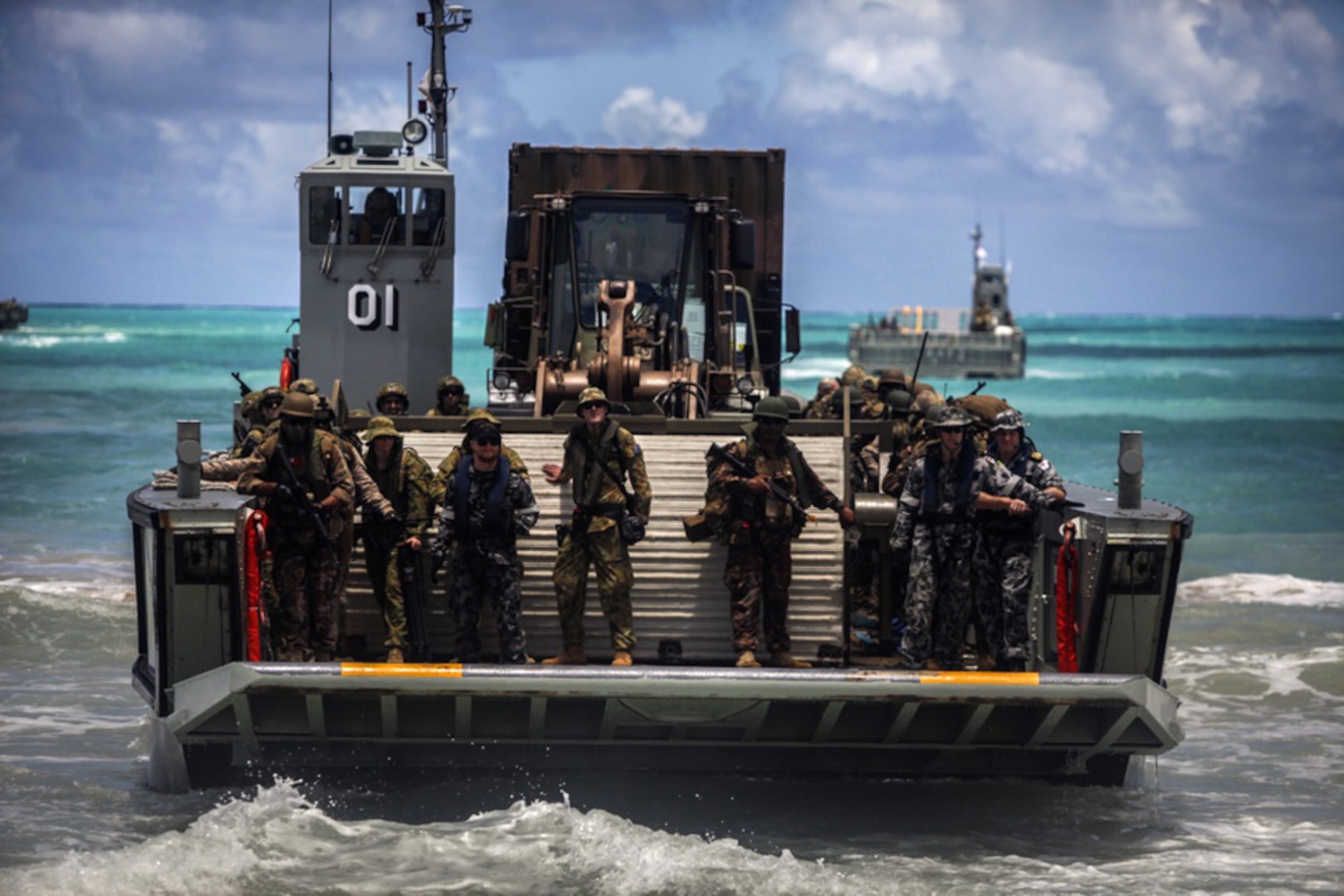 A Royal Australian Navy LHD Landing Craft, transports Australian, New Zealand, Tongan, and U.S. armed forces to Marine Corps Training Area Bellows during Rim of the Pacific 2016 in Hawaii.  The crafts landed troops from 2nd Battalion, Royal Australian Regiment, Provisional Marine Expeditionary Brigade-Hawaii, which came from HMAS Canberra to the beach during a coordinated amphibious assault with forces from Battalion Landing Team 2nd Battalion, 3rd Marines landing on Pyramid Rock Beach from USS San Diego. The landings are a part of the free-play scenario phase of RIMPAC 16. 
