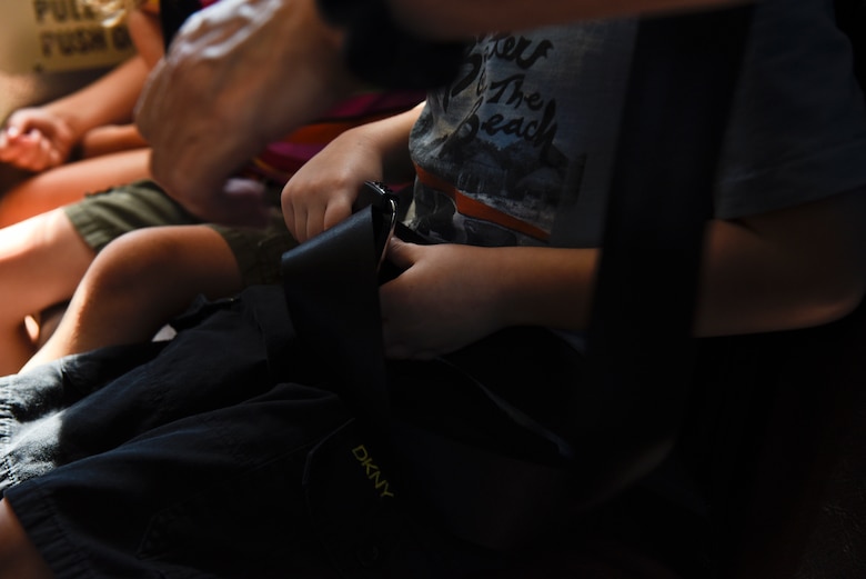 PETERSON AIR FORCE BASE, Colo. – A student learns how to buckle his seat belt on a school bus during the Buster the Bus Safety Event at the base auditorium on Peterson Air Force Base, Colo., July 26, 2016. The event was coordinated by the District 11 Transportation Safety Office due to the implementation of safety belts and to ensure kids know proper bus safety. (U.S. Air Force photo by Senior Airman Rose Gudex)