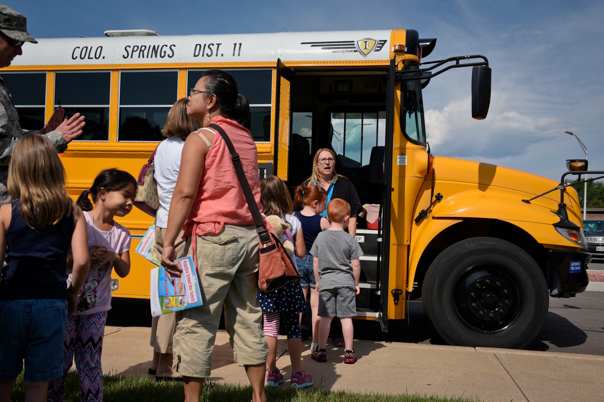 PETERSON AIR FORCE BASE, Colo. – Children line up to board a school bus to learn safety tips during the Buster the Bus Safety Event at the base auditorium on Peterson Air Force Base, Colo., July 26, 2016. Children and their parents learned how to fasten the newly implemented seat belts, ride the bus safely and to evacuate safely in the event of an emergency. (U.S. Air Force photo by Senior Airman Rose Gudex)