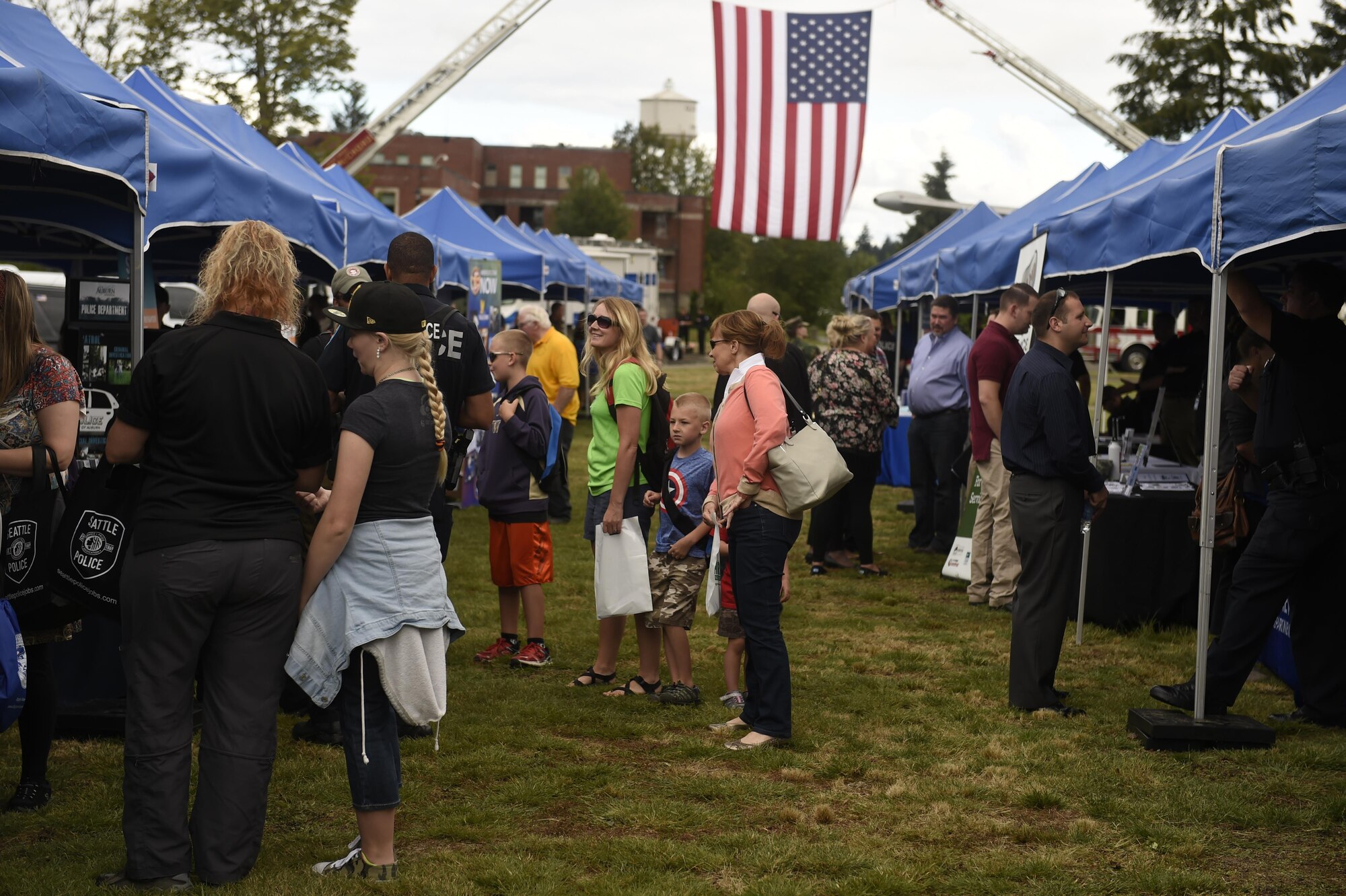 Police Officers with the Seattle Police Department mounted division, answer questions from visitors at the “Stand with Those Who Serve,” annual public safety appreciation event July 23, 2016 at Joint Base Lewis-McChord, Wash. 38 different first responder agencies participated in the event, to include city, county state and federal agencies. (U.S. Air Force photo/Tech. Sgt. Tim Chacon) 
