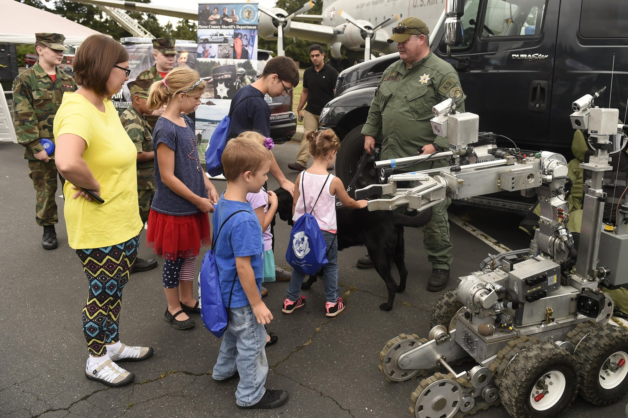 Visitors at the “Stand with Those Who Serve,” annual public safety appreciation event talk with members of the Pierce County Sheriff’s bomb squad July 23, 2016 at Joint Base Lewis-McChord, Wash. The event aimed to honor and bring together members of the area’s first responder community. (U.S. Air Force photo/Tech. Sgt. Tim Chacon) 