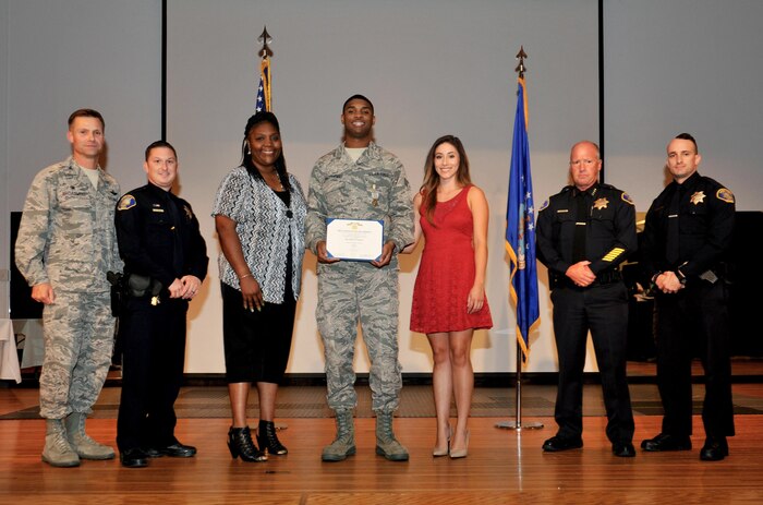 Senior Airman Terron Matthews, 9th Aircraft Maintenance Squadron Assistant Dedicated Crew Chief (center) is presented the Airman’s Medal July 29, 2016, at Beale Air Force Base, California. Matthews was Awarded the medal for heroic actions in saving a fellow Airman’s life on May 18, 2015. (U.S. Air Force photo by Staff Sgt. Jeffrey M. Schultze)