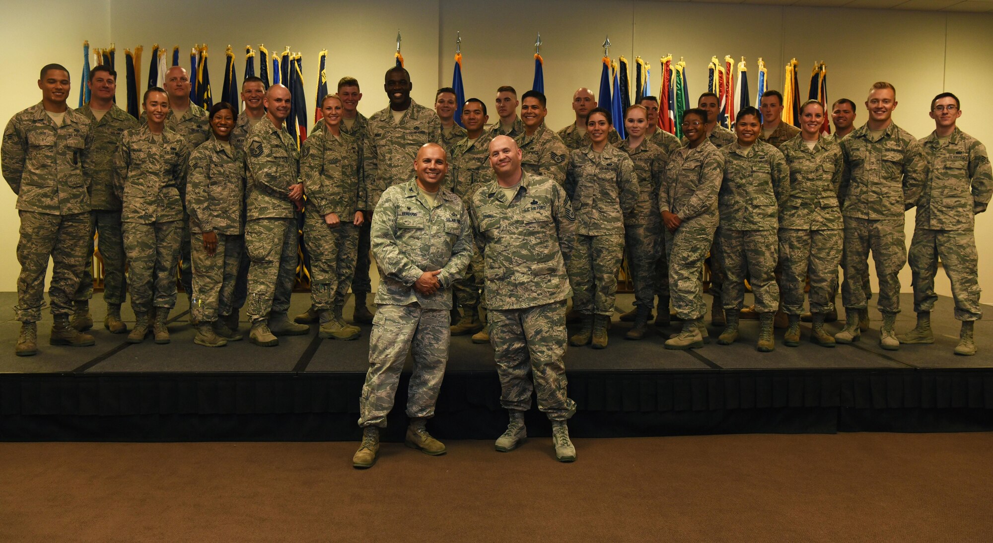 Enlisted F.E. Warren Airmen who promoted in July pose for a photo with Warren Leadership, Aug. 1, 2016, at F.E. Warren Air Force Base, Wyo. Each month the Mighty Ninety hosts a celebration for enlisted promotees from the base. (U.S. Air Force photo by Airman 1st Class Breanna Carter)