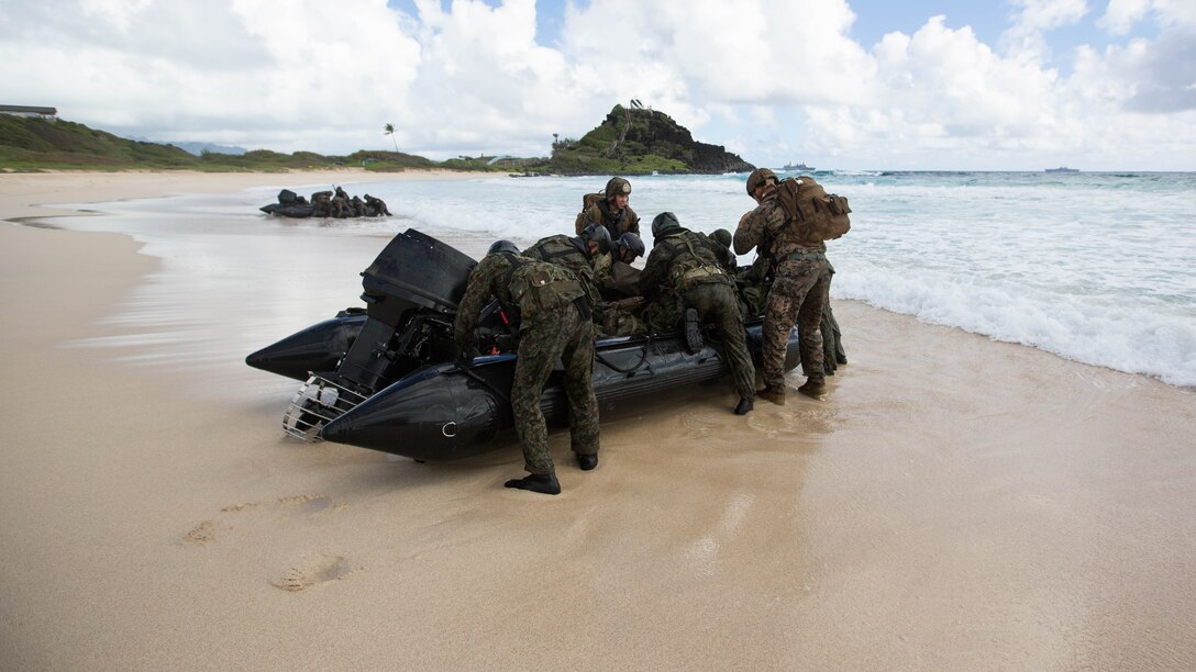 Japanese reconnaissance soldiers and U.S. Marines with 5th Air Naval Gunfire Liaison Company assault a beach during Rim of the Pacific 2016.  The assault was launched from USS San Diego and commanded by III Marine Expeditionary Force units aboard USS America.  Twenty-six nations, more than 40 ships and submarines, more than 200 aircraft and 25,000 personnel are participating in RIMPAC from June 30 to Aug. 4, in and around the Hawaiian Islands and Southern California. 