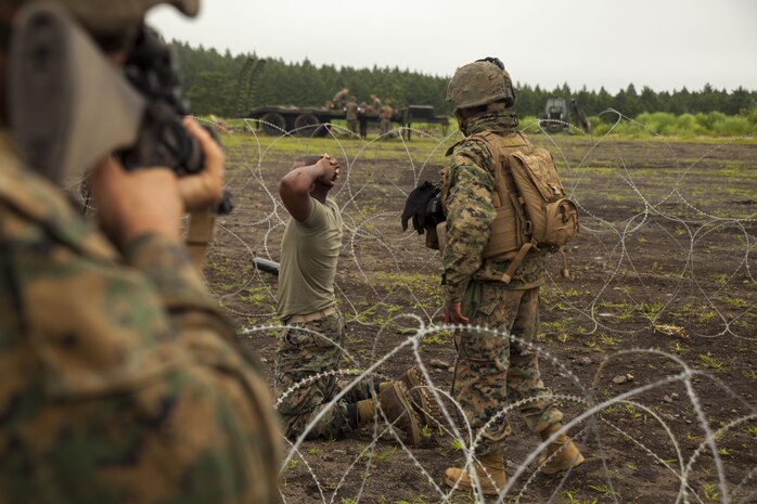 U.S. Marine Corps Lance Cpl. Tarah Doh, a combat engineer with Marine Wing Support Squadron (MWSS) 171 stationed at Marine Corps Air Station Iwakuni, Japan, prepares to search a captured simulated enemy combatant during Exercise Eagle Wrath 2016 at Combined Arms Training Center Camp Fuji, July 27, 2016. During the culminating event, Marines established a mock air base including a landing zone and refueling point, constructed defensive and machine-gun positions, and conducted convoys and patrols over the course of four days. MWSS-171 conducts this exercise once a year in order to train all the Marines within the squadron, enhance their technical skills, field experience and military occupational specialty capability. (U.S. Marine Corps photo by Lance Cpl. Aaron Henson)