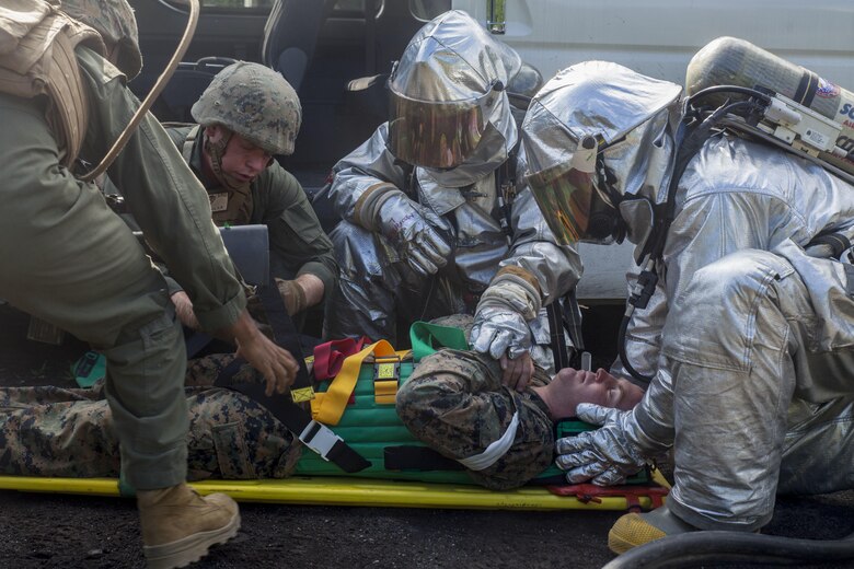 Expeditionary fire rescue Marines with Marine Wing Support Squadron 171 stationed at Marine Corps Air Station Iwakuni, Japan, secure a simulated downed pilot during Exercise Eagle Wrath 2016 at Combined Arms Training Center Camp Fuji, July 29, 2016. During the exercises culminating event, Marines established a mock air base including a landing zone and refueling point, constructed defensive and machine-gun positions, and conducted convoys and patrols over the course of four days. (U.S. Marine Corps photo by Lance Cpl. Aaron Henson)