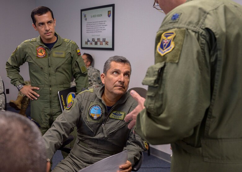 Colombian Air Force Brig. Gen. Sergio Andrés Garzón Vélez, Combined Forces Air Component Commander for PANAMAX 16, and his aid Lt. Col. Ricardo, receive an update during a commander’s update briefing at Davis-Monthan AFB, Ariz., July 31, 2016.  PANAMAX is an annual exercise sponsored by U.S. Southern Command that increases the ability of nations to work together, enable assembled forces to organize as a multinational task force and test their responsiveness in combined operations. (U.S. Air Force photo by Tech. Sgt. Heather R. Redman)