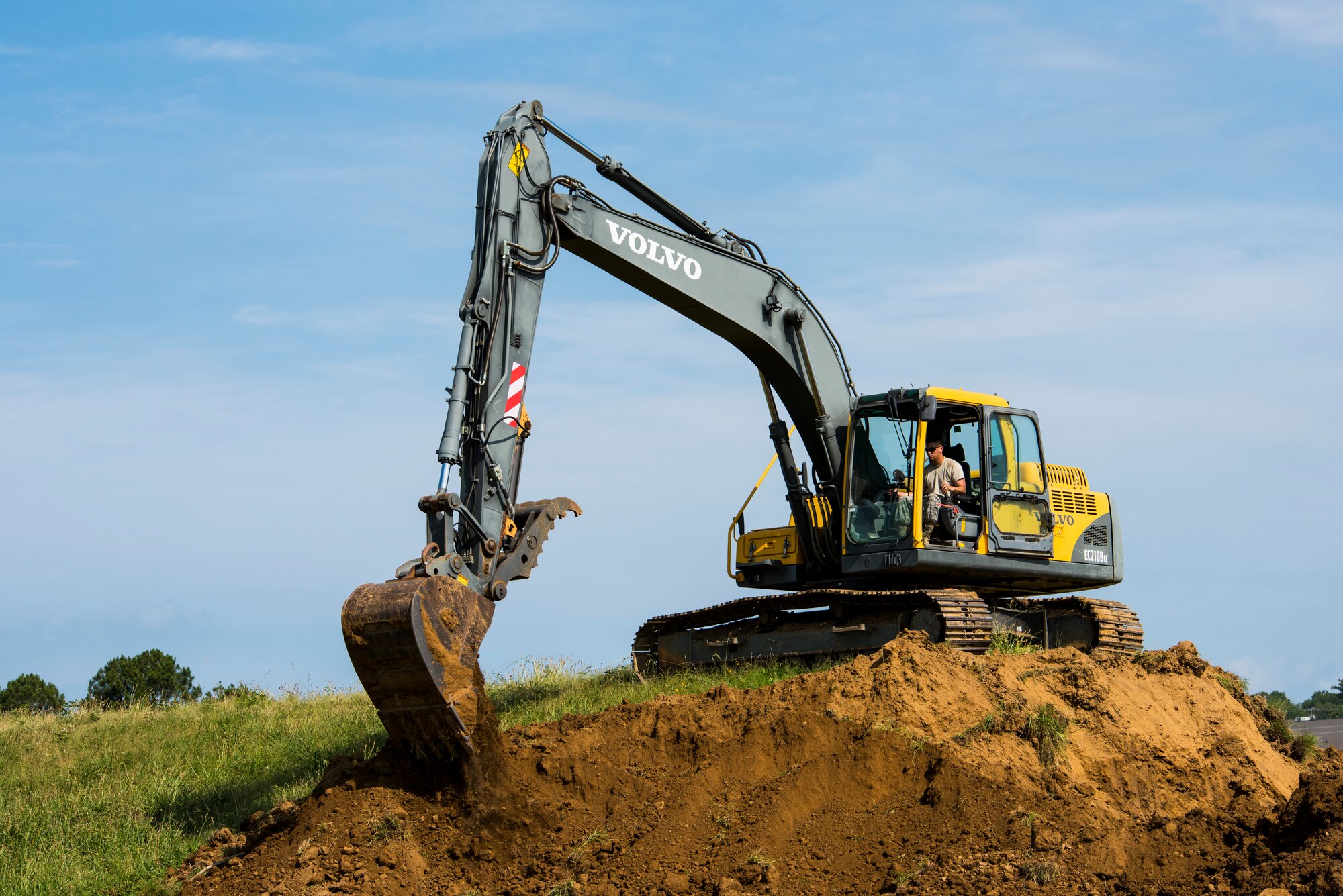 Senior Airman Adam Brannon, 188th Civil Engineer Squadron heavy equipment operator, operates an excavator June 24, 2016, to remove dirt from the west hammerhead arm dearm berm at Ebbing Air National Guard Base, Fort Smith, Ark. The 188th CES removed 1,400 cubic yards of dirt by the end of the weekend and plan to remove the rest of the berm in August. (U.S. Air National Guard photo by Senior Airman Cody Martin/Released)