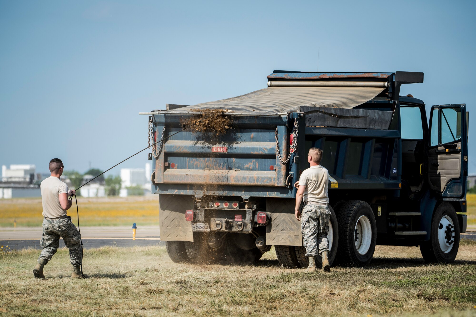 188th Civil Engineer Squadron heavy equipment operators remove dirt from the west hammerhead arm dearm berm June 24, 2016, at Ebbing Air National Guard Base, Fort Smith, Ark. The 188th CES removed 1,400 cubic yards of dirt by the end of the weekend and plan to remove the rest of the berm in August. (U.S. Air National Guard photo by Senior Airman Matthew Matlock/Released)