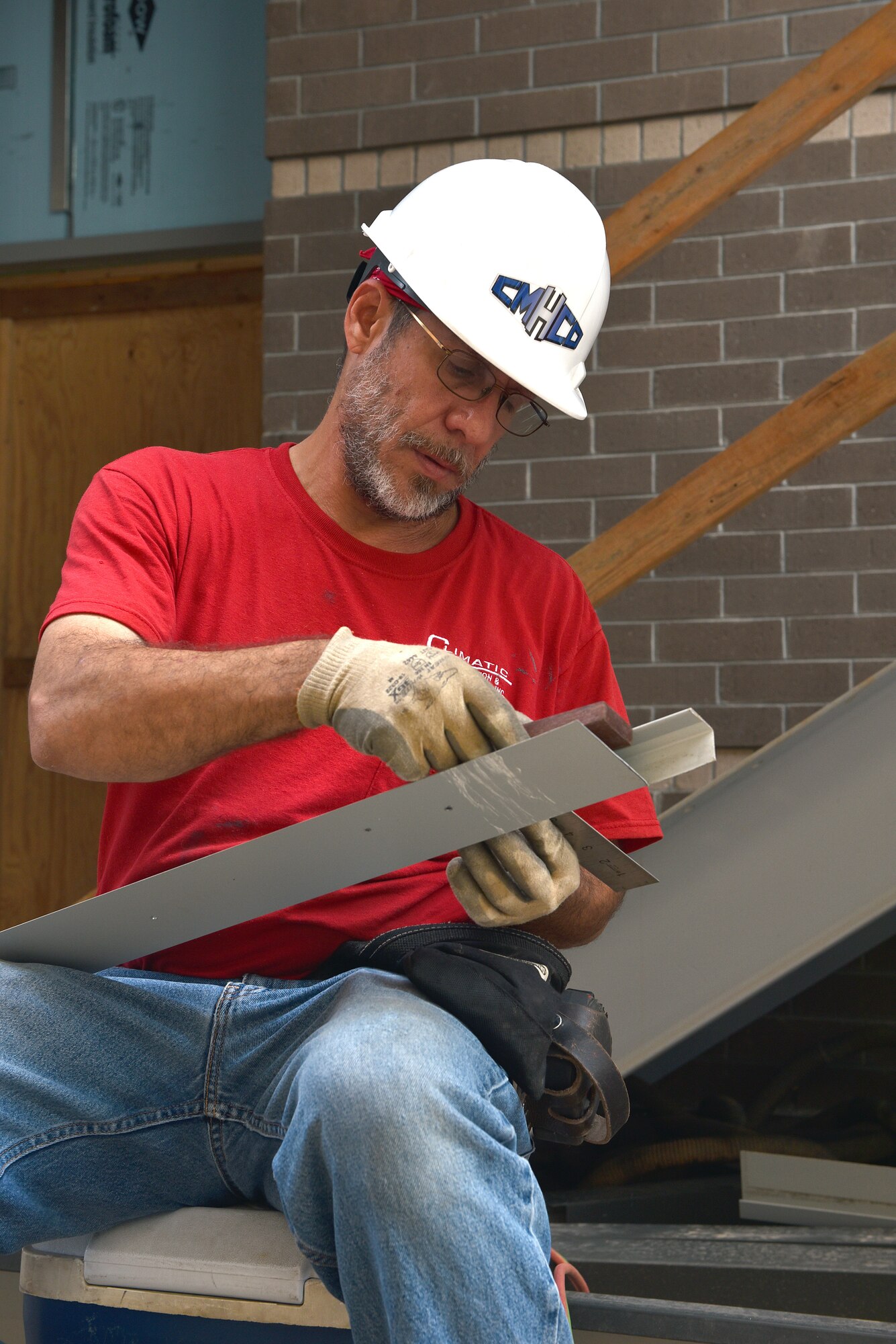 A construction worker measures a piece of heavy-gauge siding, August 1, 2016, at the I.G. Brown Training and Education Center in Louisville, Tenn. Work on the Air National Guard training center's new dormitory and classroom facility broke ground nearly two years ago and is nearing completion. The facility will contain approximately 47,000 square feet of additional space. (U.S. Air National Guard photo by Master Sgt. Mike R. Smith)
