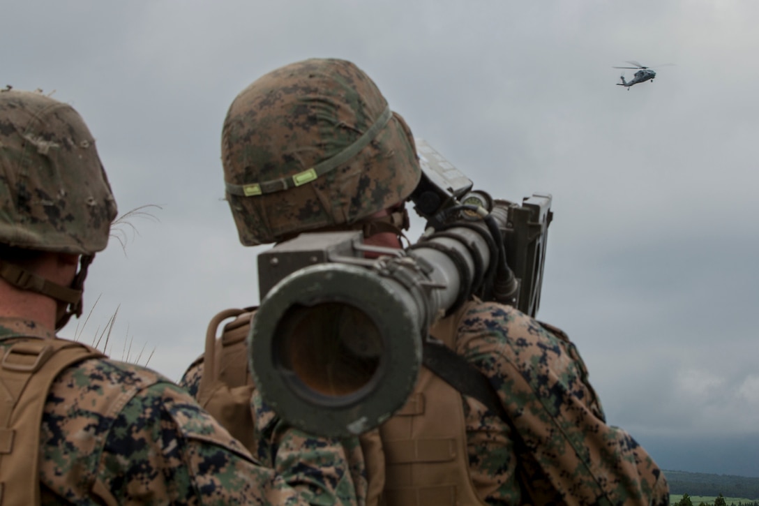 U.S. Marine Corps Cpl. Johnston Murn, a low altitude air defense gunner with 3rd LAAD Battalion unit deployment program, uses a Stinger missile tracking and handling trainer on a Sikorsky MH-60S Seahawk with Helicopter Sea Combat Squadron (HSC) 25 during Exercise Eagle Wrath 2016 at Combined Arms Training Center Camp Fuji, July 28, 2016. Marine Wing Support Squadron 171 stationed at Marine Corps Air Station Iwakuni, Japan, received assistance throughout the exercise from Combat Logistics Company 36 from MCAS Iwakuni, the Low Altitude Air Defense Battalion and Marine Air Traffic Control Mobile Team from the 31st Marine Expeditionary Unit and HSC-25 from Andersen Air Force Base, Guam. (U.S. Marine Corps photo by Lance Cpl. Aaron Henson)